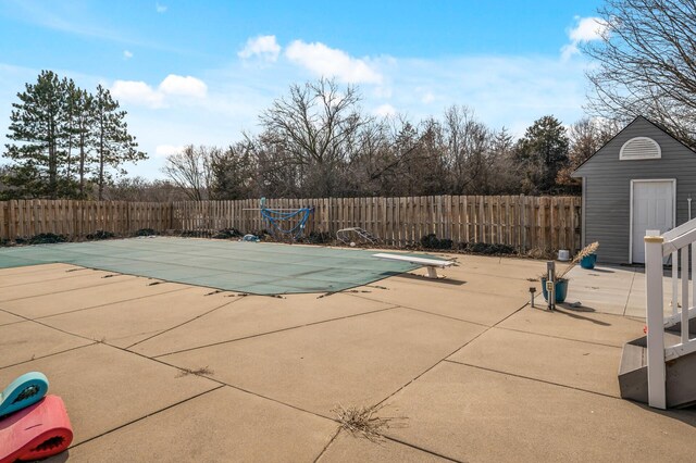 view of swimming pool with a patio area, a fenced in pool, and a fenced backyard