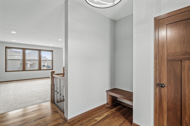 hall featuring recessed lighting, an upstairs landing, and wood finished floors