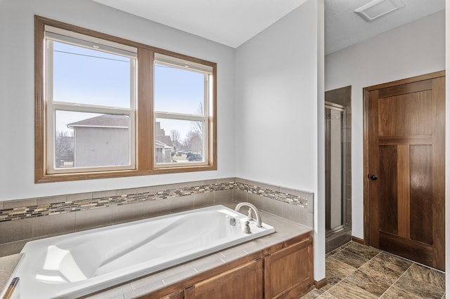 full bath featuring a stall shower, a garden tub, and visible vents