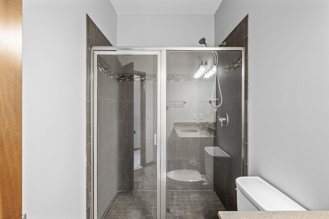 bathroom with toilet and a shower stall