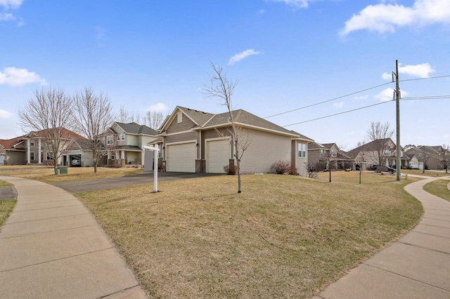 view of home's exterior featuring a yard, a garage, a residential view, and driveway