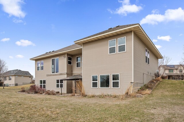 back of property with a yard