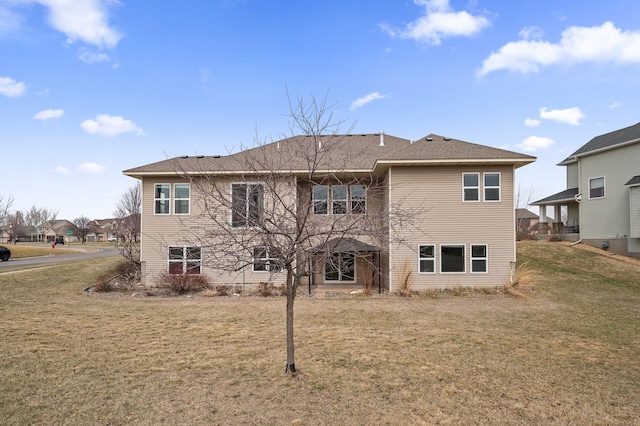 back of property with a lawn