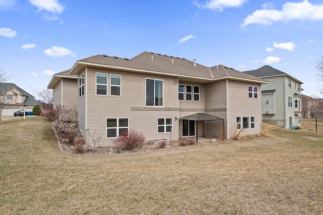 back of property featuring a lawn