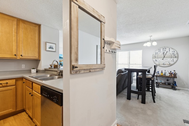 kitchen with an inviting chandelier, a sink, light countertops, a textured ceiling, and dishwasher