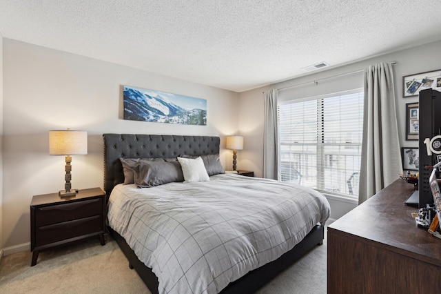 bedroom with light carpet, visible vents, a textured ceiling, and baseboards