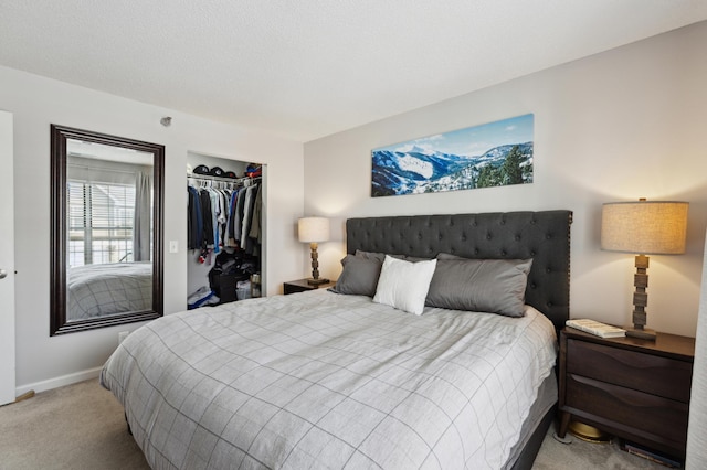 bedroom with a closet, baseboards, and light colored carpet