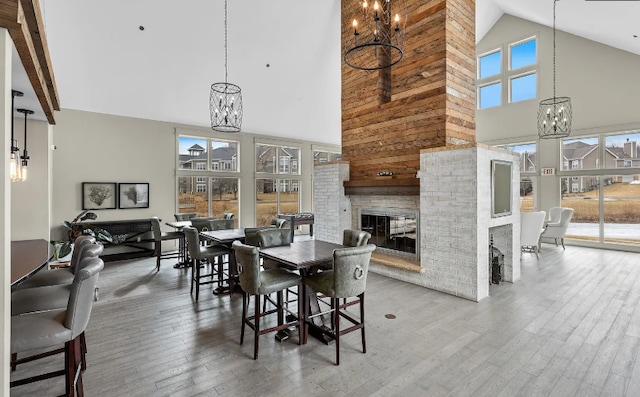 dining room featuring an inviting chandelier, hardwood / wood-style flooring, and a fireplace