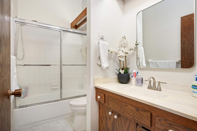 full bath featuring toilet, bath / shower combo with glass door, and vanity