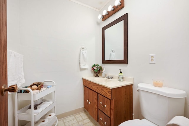 bathroom featuring tile patterned floors, vanity, toilet, and baseboards