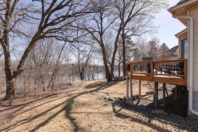 view of yard with a deck with water view