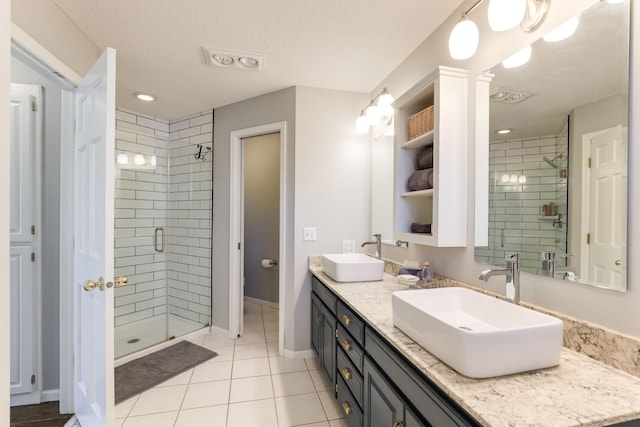 full bath with a sink, visible vents, baseboards, and a stall shower