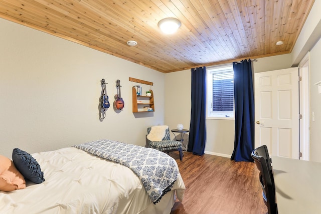 bedroom with wood ceiling, wood finished floors, and baseboards