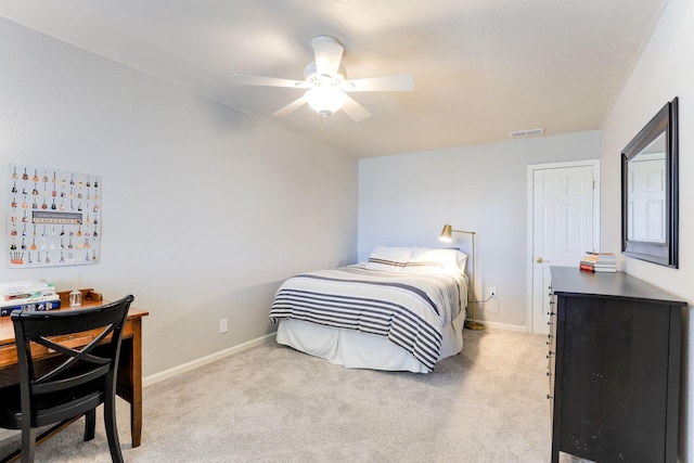 carpeted bedroom with visible vents, baseboards, and a ceiling fan