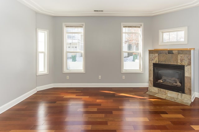 5640 Winnetka Ave N, New Hope, MN 55428 - unfurnished living room with a tiled fireplace, wood-type flooring, and a wealth of natural light