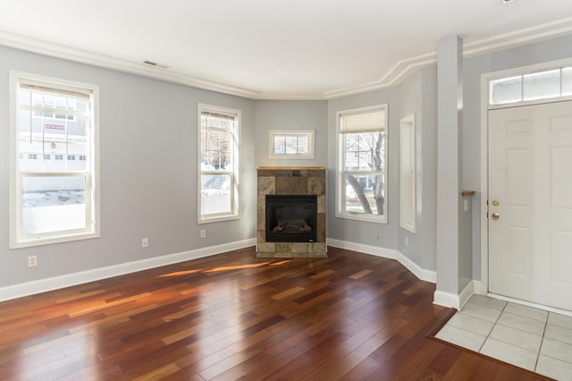 5640 Winnetka Ave N, New Hope, MN 55428 - entrance foyer featuring hardwood / wood-style floors, a tile fireplace, visible vents, and plenty of natural light