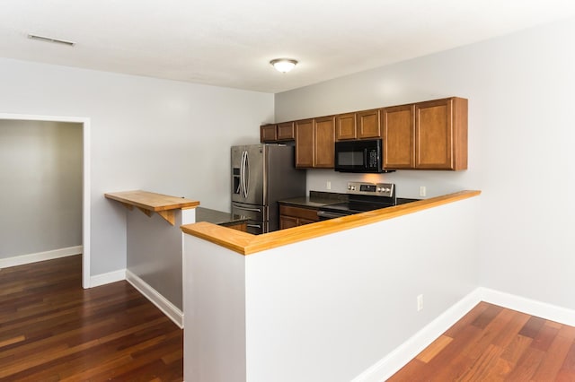 5640 Winnetka Ave N, New Hope, MN 55428 - kitchen featuring dark wood finished floors, a peninsula, stainless steel appliances, butcher block countertops, and baseboards