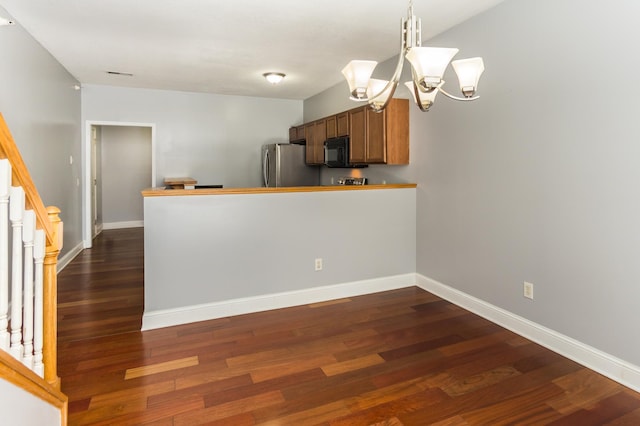 5640 Winnetka Ave N, New Hope, MN 55428 - kitchen featuring a notable chandelier, black microwave, dark wood-style floors, and freestanding refrigerator