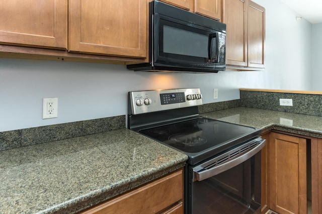5640 Winnetka Ave N, New Hope, MN 55428 - kitchen with brown cabinetry, black microwave, and stainless steel electric stove