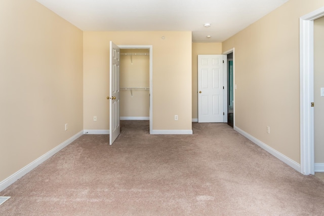 5640 Winnetka Ave N, New Hope, MN 55428 - unfurnished bedroom featuring a closet, baseboards, a walk in closet, and light colored carpet