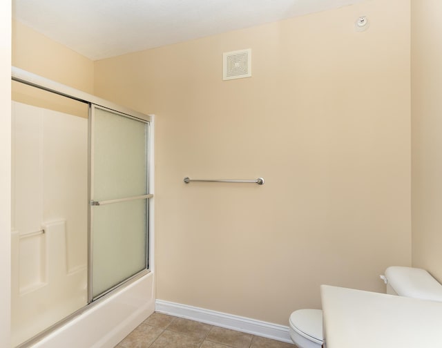 5640 Winnetka Ave N, New Hope, MN 55428 - bathroom with tile patterned flooring, baseboards, toilet, and bath / shower combo with glass door