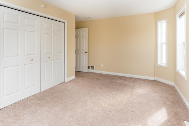 5640 Winnetka Ave N, New Hope, MN 55428 - unfurnished bedroom featuring carpet, visible vents, and multiple windows