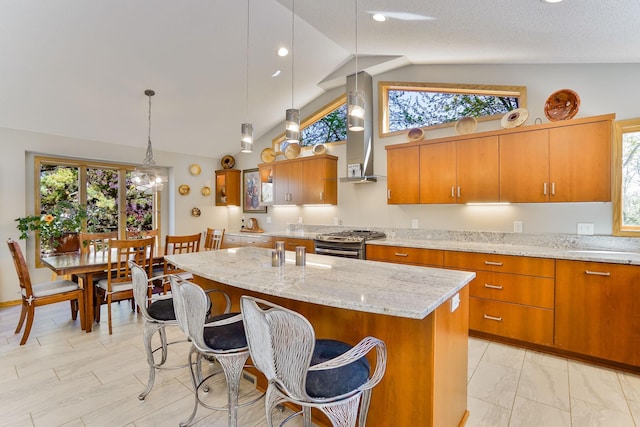 1950 Park Ridge Ct, Chaska, MN 55318 - kitchen featuring stainless steel gas range oven, brown cabinets, healthy amount of natural light, wall chimney range hood, and recessed lighting