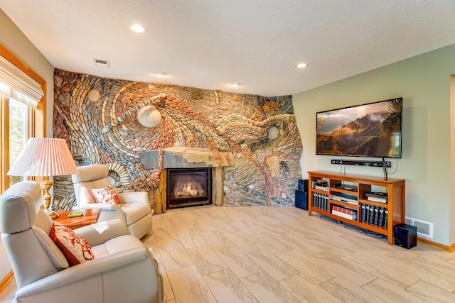 1950 Park Ridge Ct, Chaska, MN 55318 - living area featuring a glass covered fireplace, recessed lighting, a textured ceiling, and baseboards