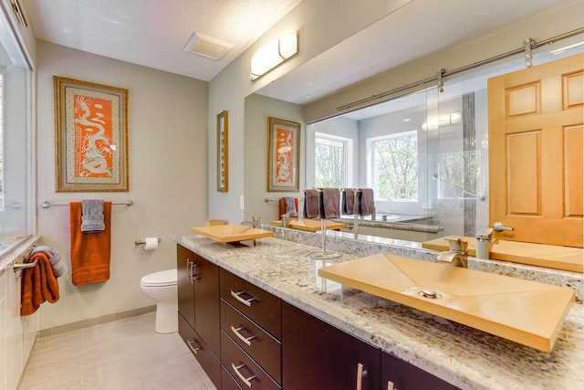 1950 Park Ridge Ct, Chaska, MN 55318 - bathroom featuring baseboards, toilet, a shower with door, and double vanity