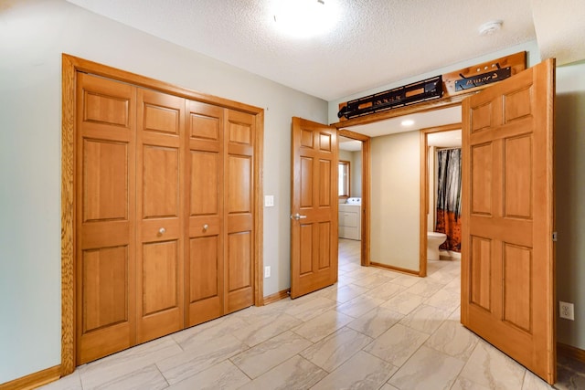 1950 Park Ridge Ct, Chaska, MN 55318 - unfurnished bedroom with washer / clothes dryer, a textured ceiling, a closet, and baseboards