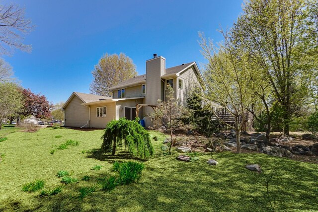 1950 Park Ridge Ct, Chaska, MN 55318 - rear view of house with a chimney and a yard