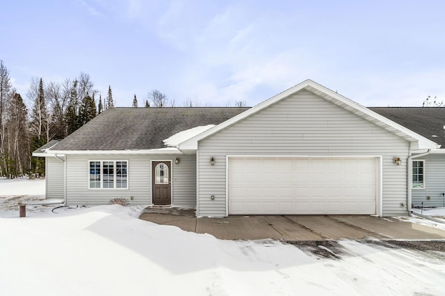 ranch-style house with a garage and a shingled roof