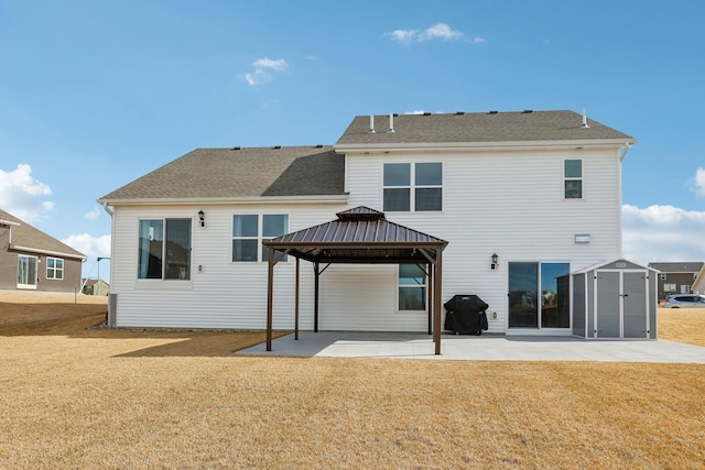 12273 71st Ct NE, Otsego, MN 55330 - rear view of house with a gazebo, a patio area, a lawn, a shed, and an outbuilding