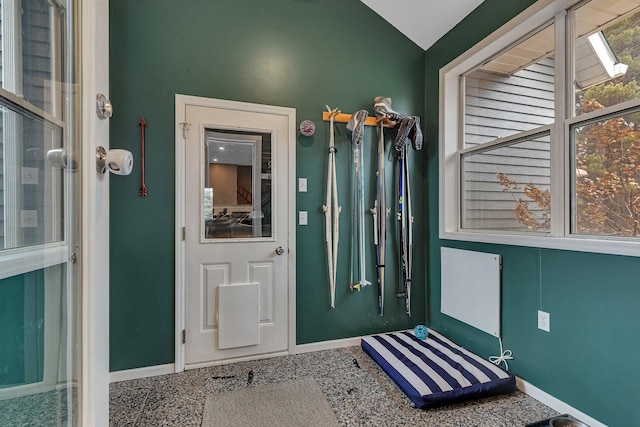 entrance foyer with lofted ceiling and baseboards