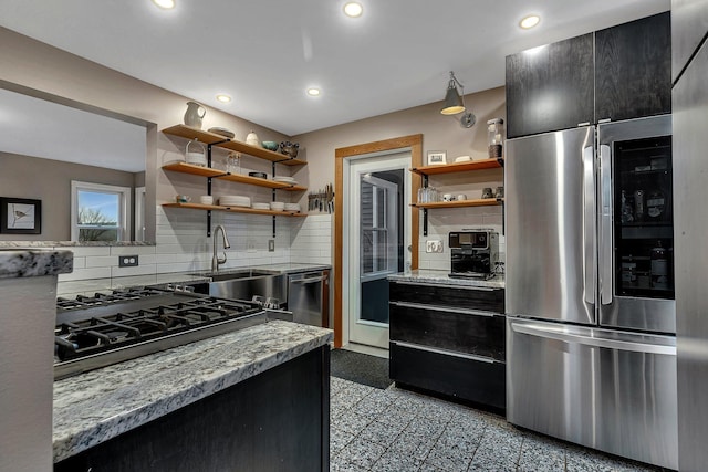 kitchen with open shelves, stainless steel appliances, a sink, and recessed lighting