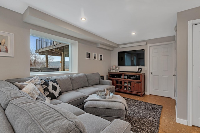 living area featuring recessed lighting and baseboards