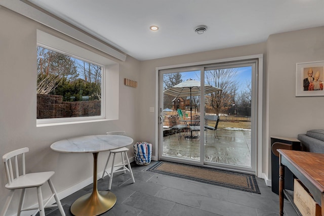 dining space with baseboards, a wealth of natural light, and recessed lighting