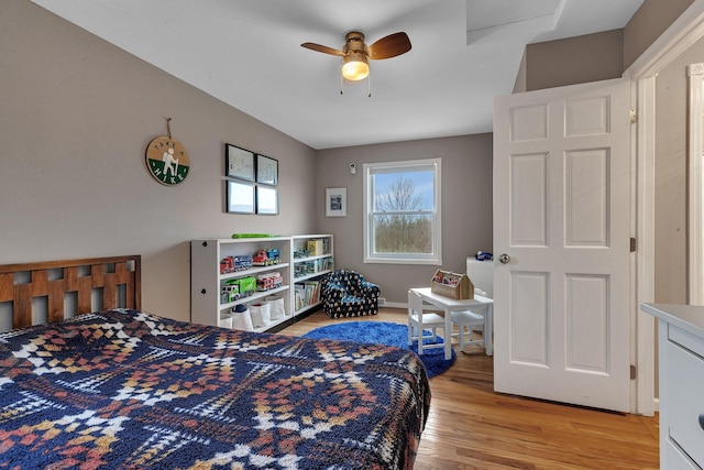 bedroom with light wood-style flooring and a ceiling fan