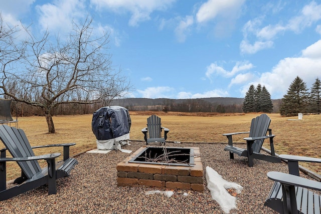 view of yard with a fire pit