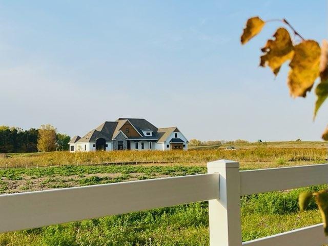 view of yard featuring a rural view and fence