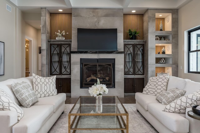 living room with a premium fireplace and visible vents