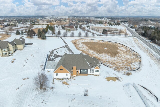 snowy aerial view featuring a residential view