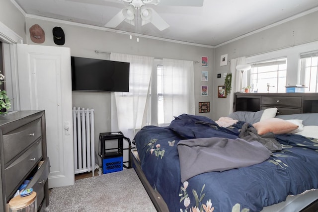 bedroom featuring a ceiling fan, radiator, and crown molding