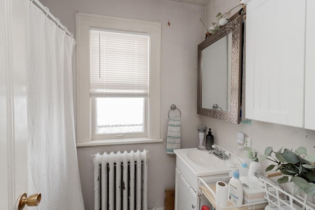 full bathroom featuring vanity and radiator