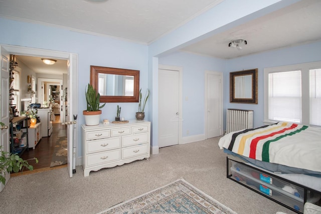 bedroom featuring crown molding, two closets, radiator, carpet flooring, and baseboards