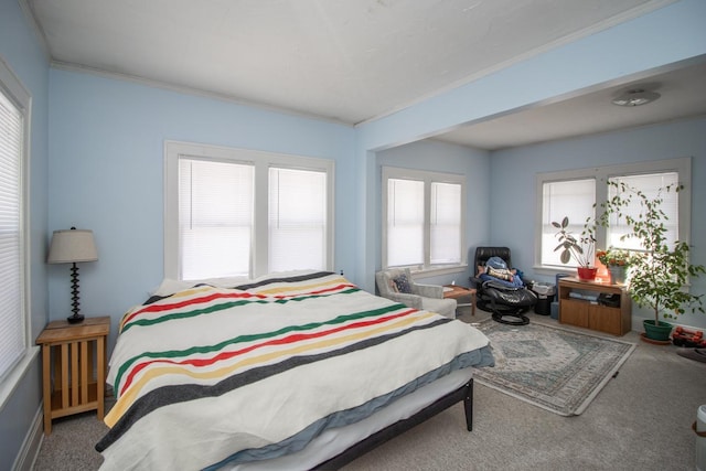 bedroom with carpet floors and crown molding