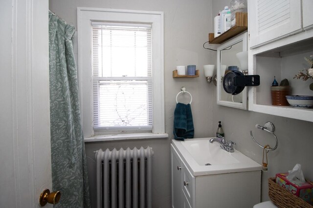 full bath with radiator heating unit and vanity