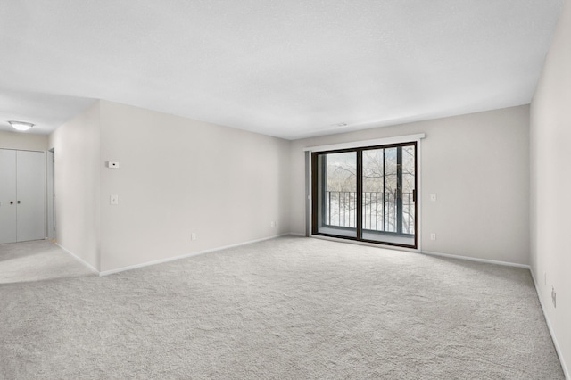 unfurnished room featuring baseboards and carpet