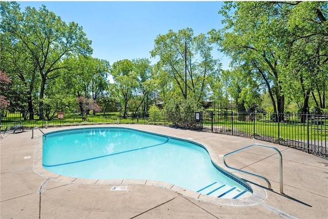 pool with a patio and fence