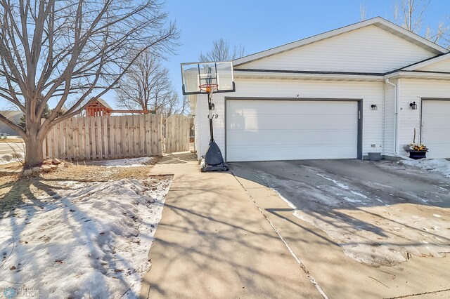 exterior space featuring fence and concrete driveway